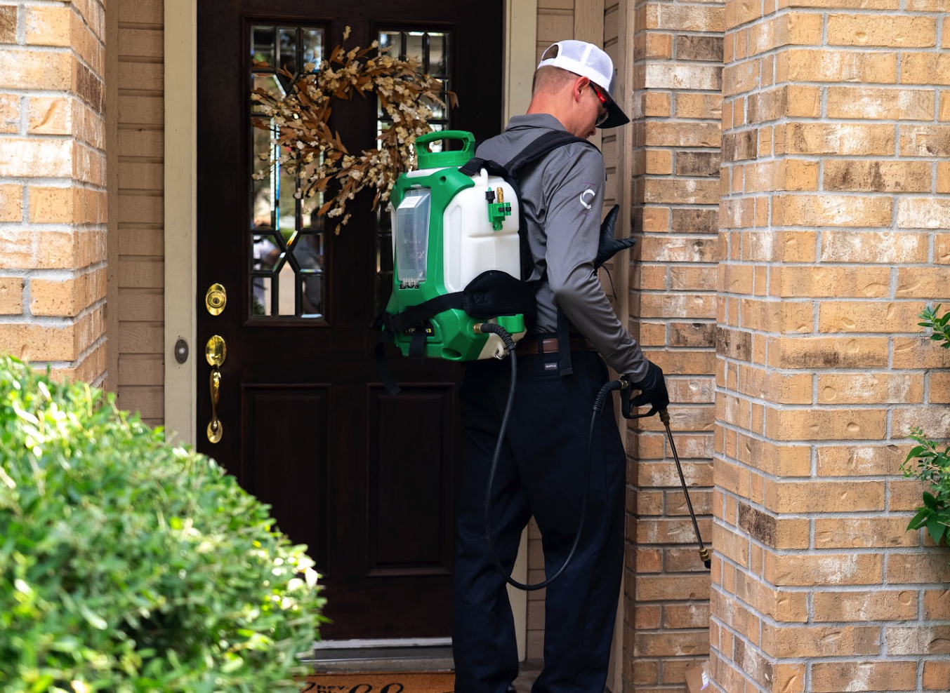Cerv Pest technician treating a home entryway