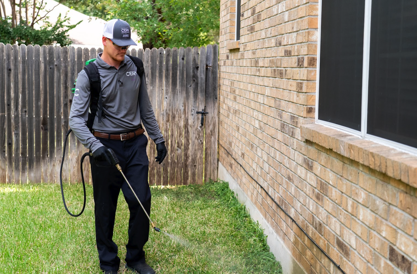 Cerv Pest technician treating the exterior perimeter of a home